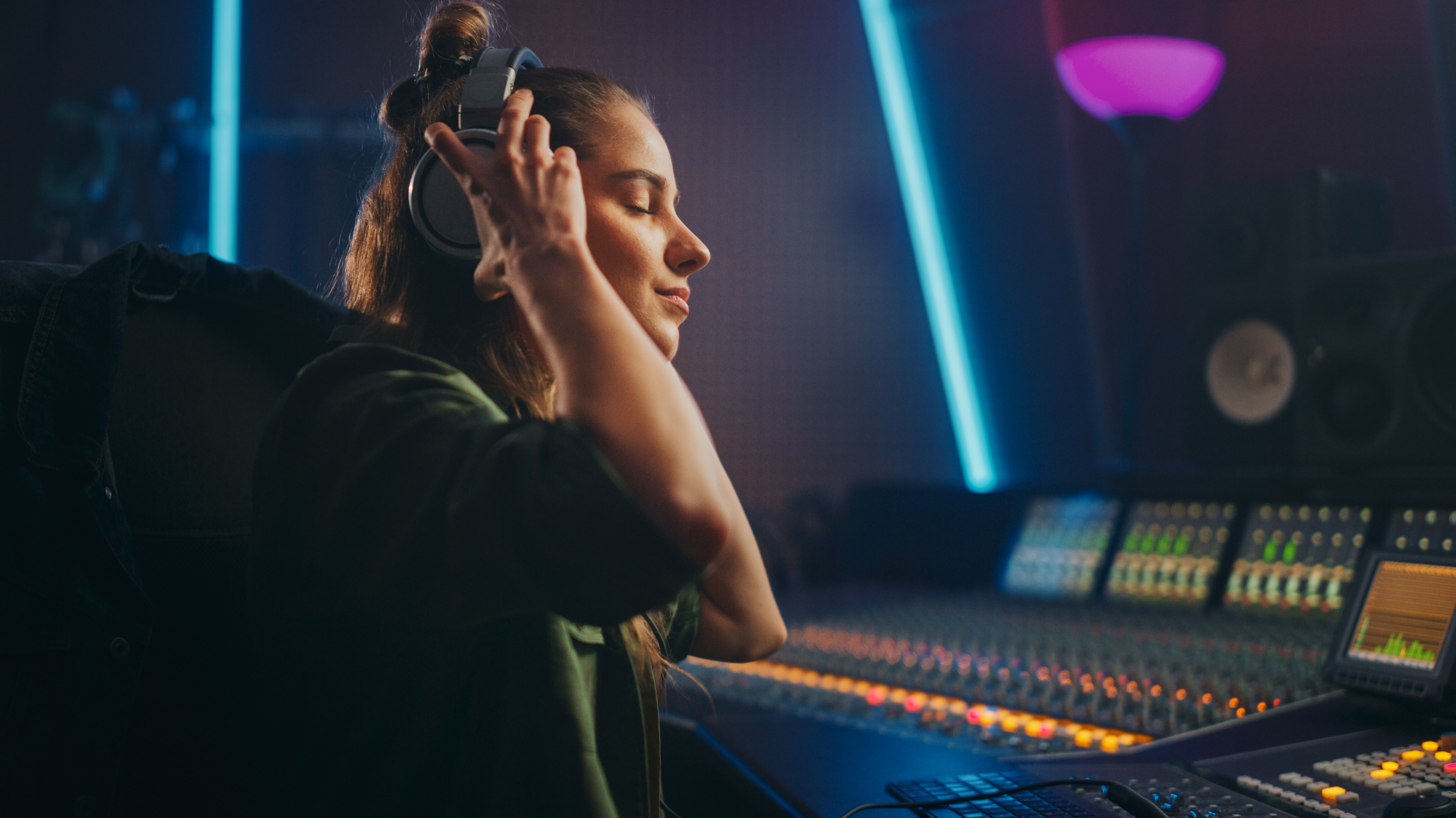 Recording Artist Listens to Music Playback as she Sits in the Studio